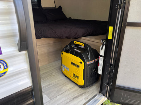 RV rental interior: A Champion 4000-watt dual-fuel generator, fire extinguisher, and a cozy bed area.