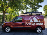 Maroon "Nature Vans" Ram Promaster City van with a Thule cargo box, ideal for rv rental adventures.