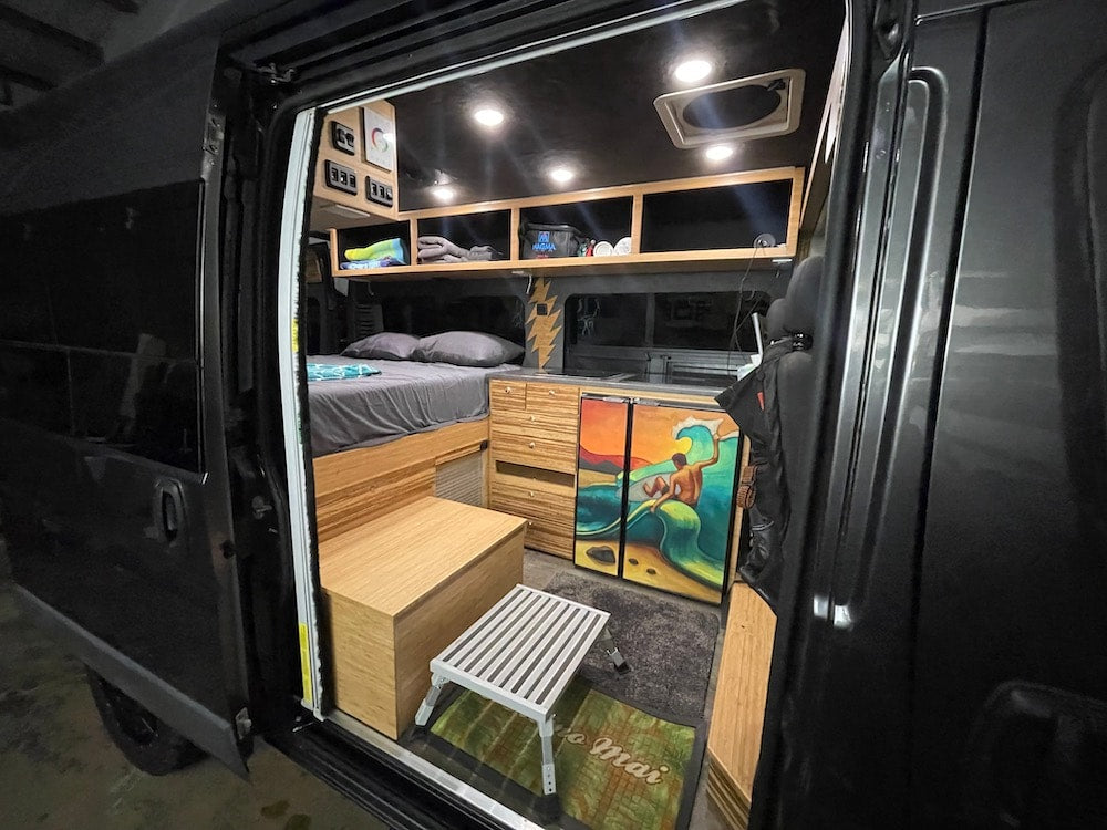  and front cabin.|Modern camper van interior for your RV rental adventure: comfy bed — photo 9