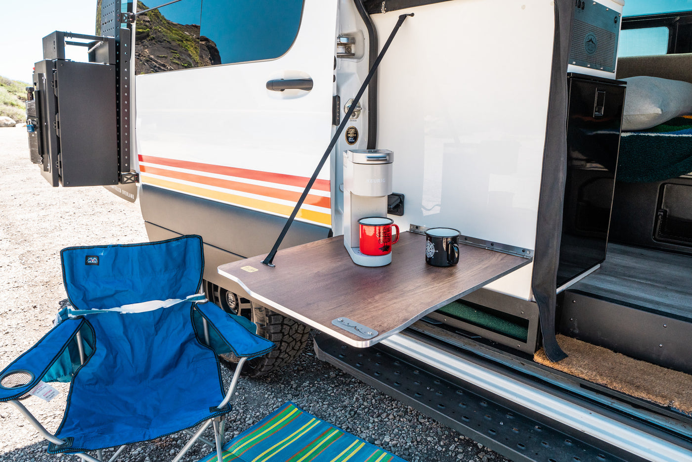 RV rental's convenient outdoor kitchen with Keurig coffee maker & mugs, plus a blue camping chair. Perfect for camp life! — photo 3