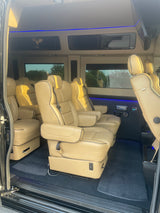 Experience luxury travel! This spacious RV rental features plush tan leather seating, blue LED lighting, and monitors for comfort.