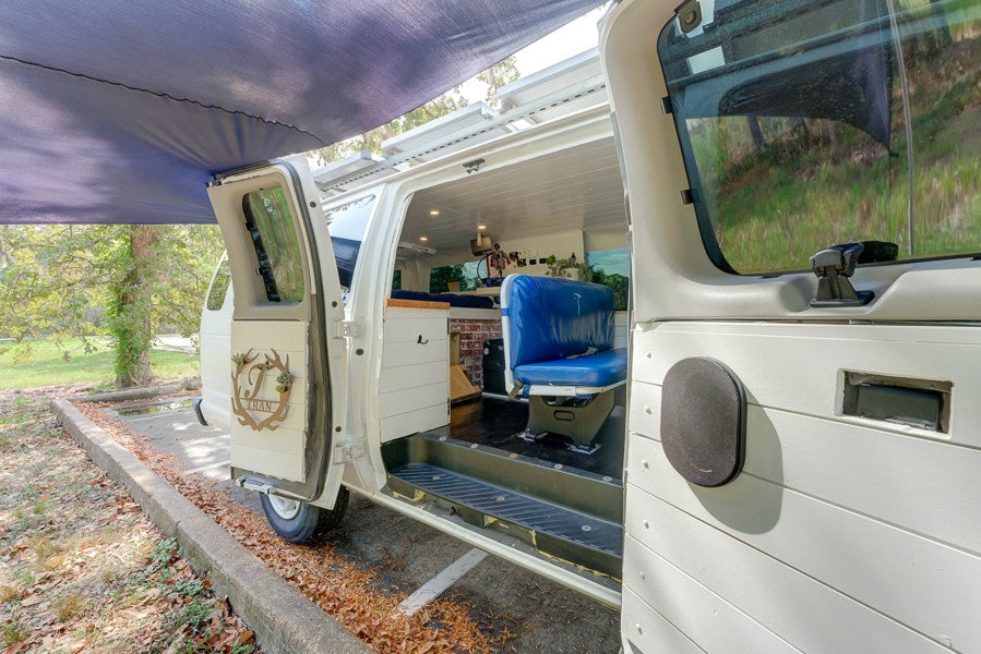 This custom RV rental camper van features an open side door