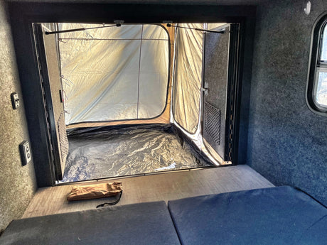 Looking from an RV rental, a spacious light-colored tent annex is attached at the rear, expanding the versatile camping area.