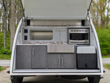 Explore with ease! This RV rental features a fully equipped outdoor kitchen in a compact camper, ready for your mobile adventures.