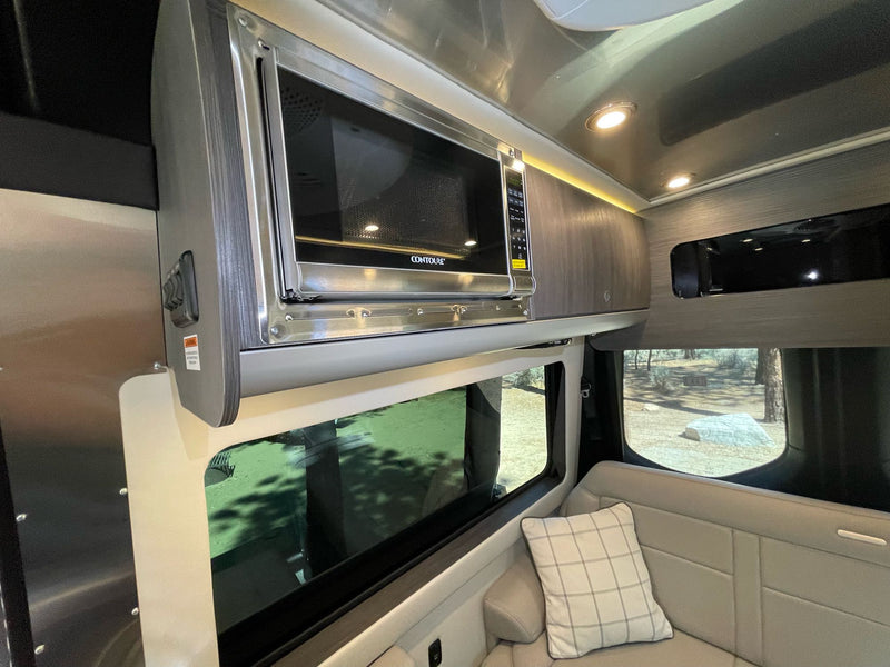  and large windows. Enjoy scenic camper van travel!|Spacious RV rental interior with plush seating — photo 9