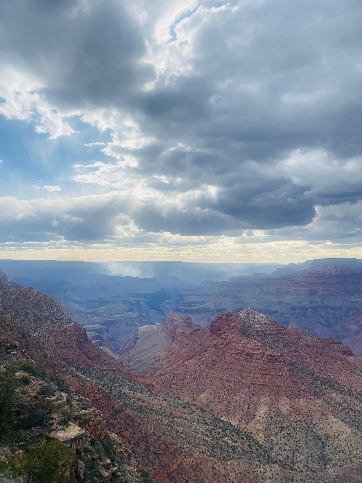 Grand Canyon vista with sun rays illuminating vast, layered rock formations. Perfect for an RV rental escape.