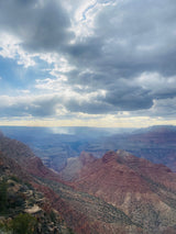 Grand Canyon vista with sun rays illuminating vast, layered rock formations. Perfect for an RV rental escape.