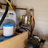 RV rental's water system, featuring a Bosch compact water heater, Shurflo pump, and filter for fresh water.