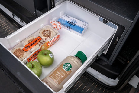 An RV rental's pull-out fridge, ideal for road trips, is stocked with Thomas' English muffins, apples, Starbucks latte, & butter.