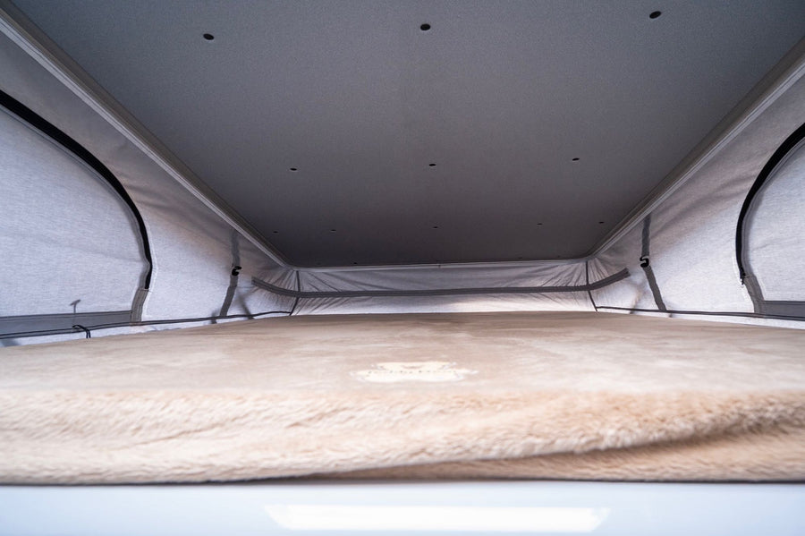  ideal for outdoor cooking. Perfect for your RV rental adventures!|An RV rental's bright interior: a ladder ascends to a loft bed