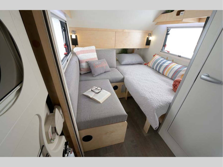 This RV rental's cozy interior features a gray sofa