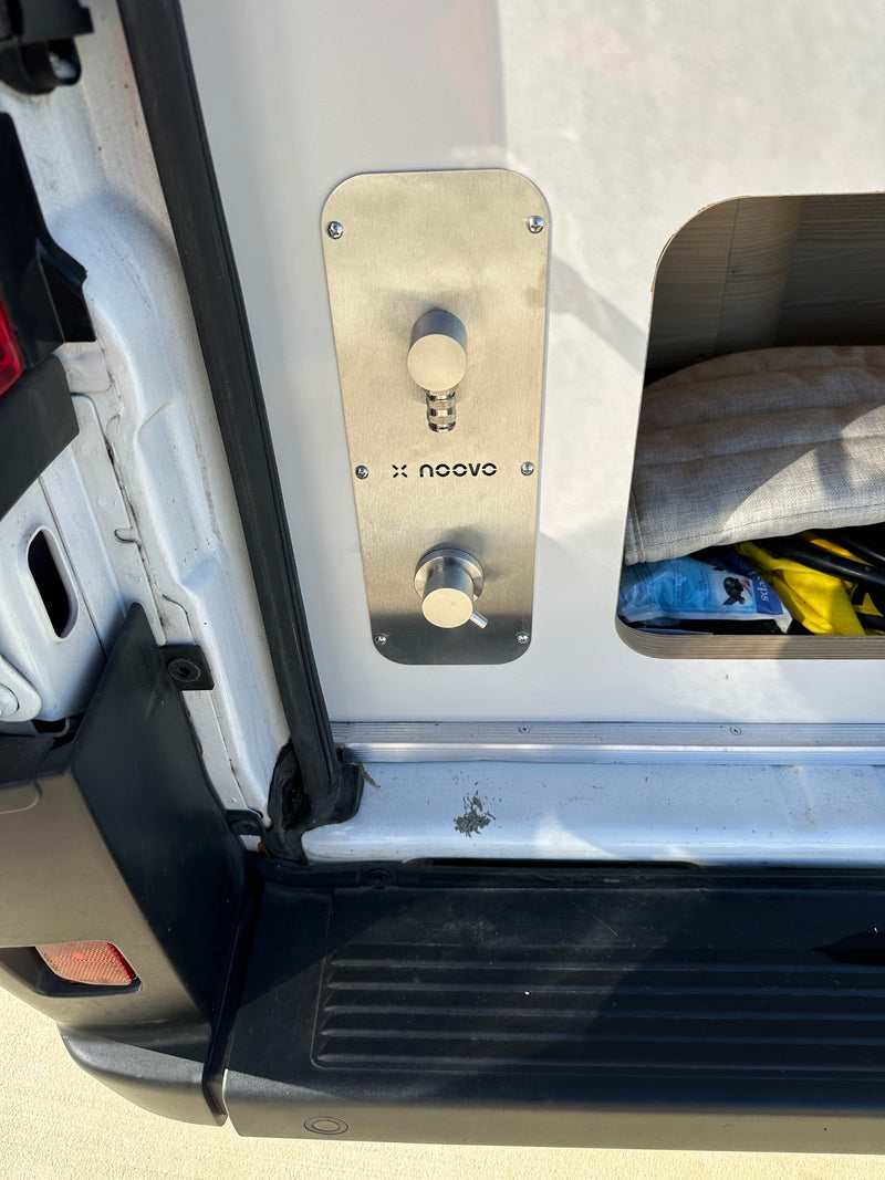 RV rental camper van's x noovo outdoor water utility panel with faucet and mixer, beside open storage. — photo 9