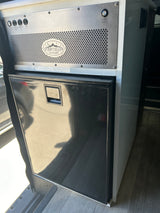 Compact Isotherm fridge & Storyteller Overland controls in this RV rental, designed for van life adventures.