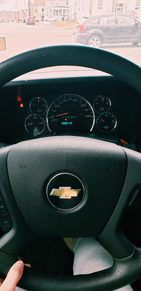 View from an RV rental driver's seat, featuring a Chevrolet steering wheel and dashboard showing 39,859 miles.