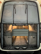 RV rental: Inside a camper van, showing smart storage panels, a neatly folded bed, and functional interior space.