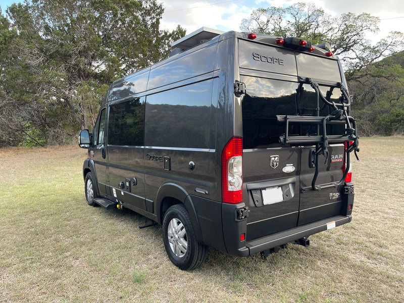 Explore in style! This dark grey Ram ProMaster "Scope" RV rental has a bike rack, solar, & is ready for adventure. — photo 4