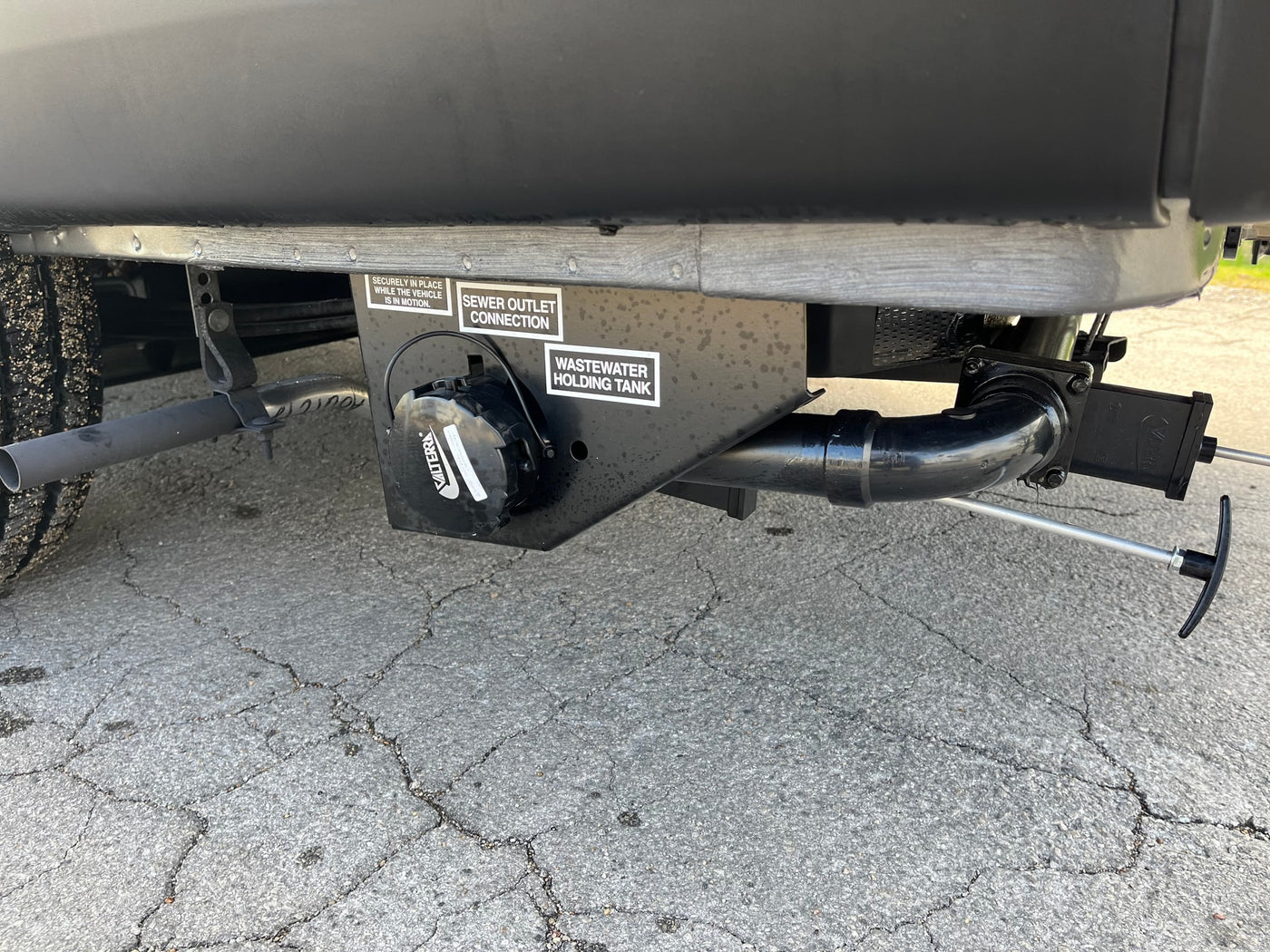 Essential RV rental feature: a Valterra wastewater holding tank and sewer outlet connection for proper waste disposal. — photo 9