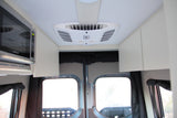 RV rental interior featuring microwave, air conditioning, and storage. Ideal for comfortable travel.