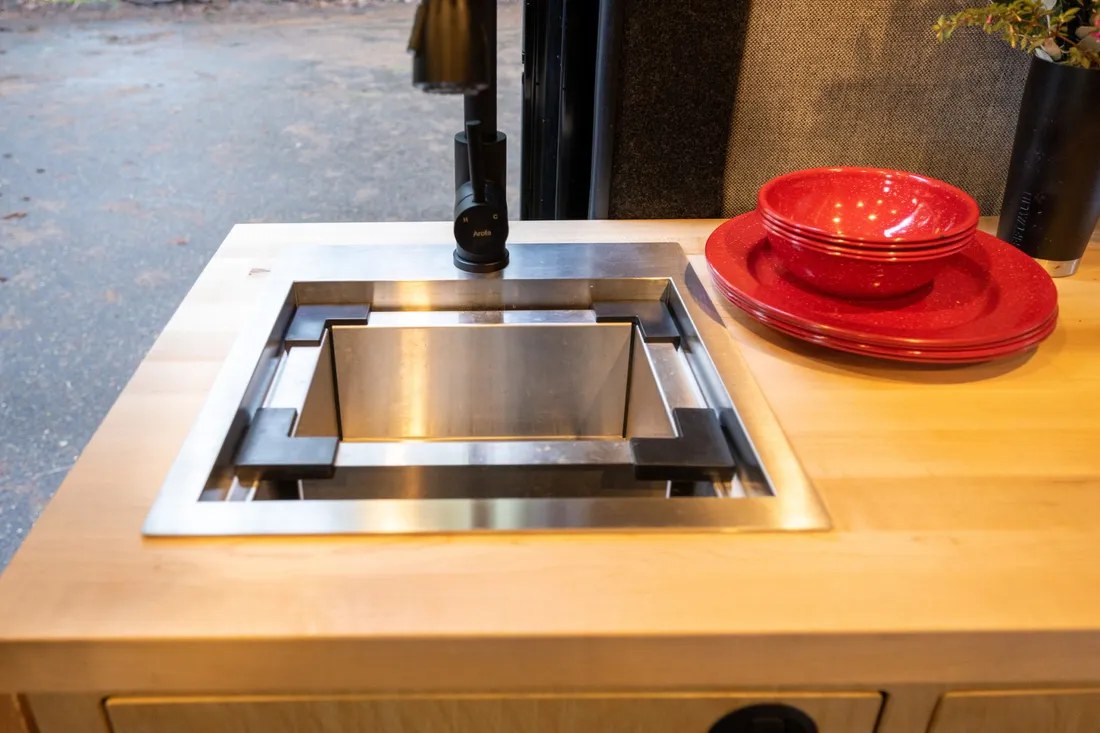  perfect for comfortable camper van trips.|Inside an rv rental: a compact kitchen with a sink — photo 5