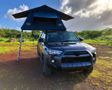This dark SUV with a Tepui rooftop tent, perfect for an RV rental adventure, set up in a scenic outdoor landscape.