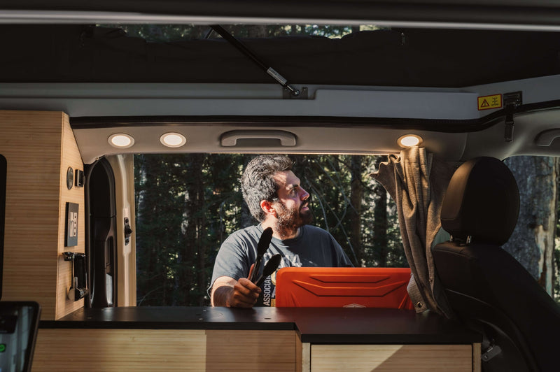  is parked in a misty evergreen forest for nature and camping.|Inside an **rv rental** — photo 6