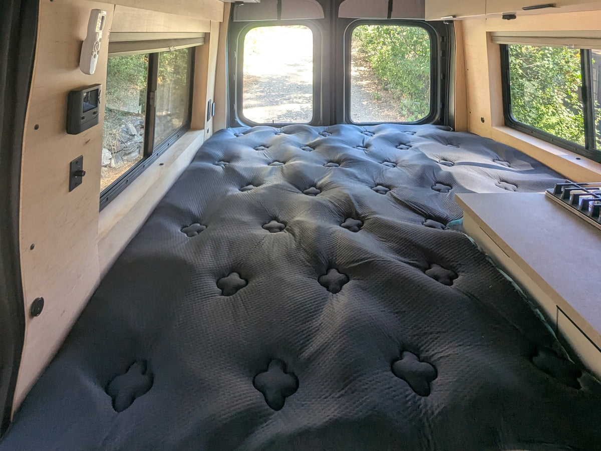  and comfy bench seating for travel.|This modern RV rental kitchen features a gas stove — photo 14