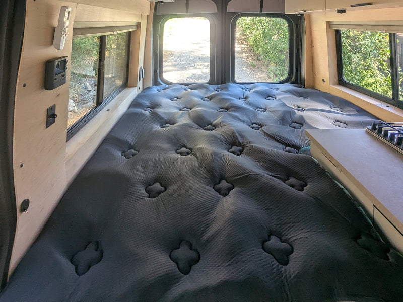  and comfy bench seating for travel.|This modern RV rental kitchen features a gas stove — photo 14