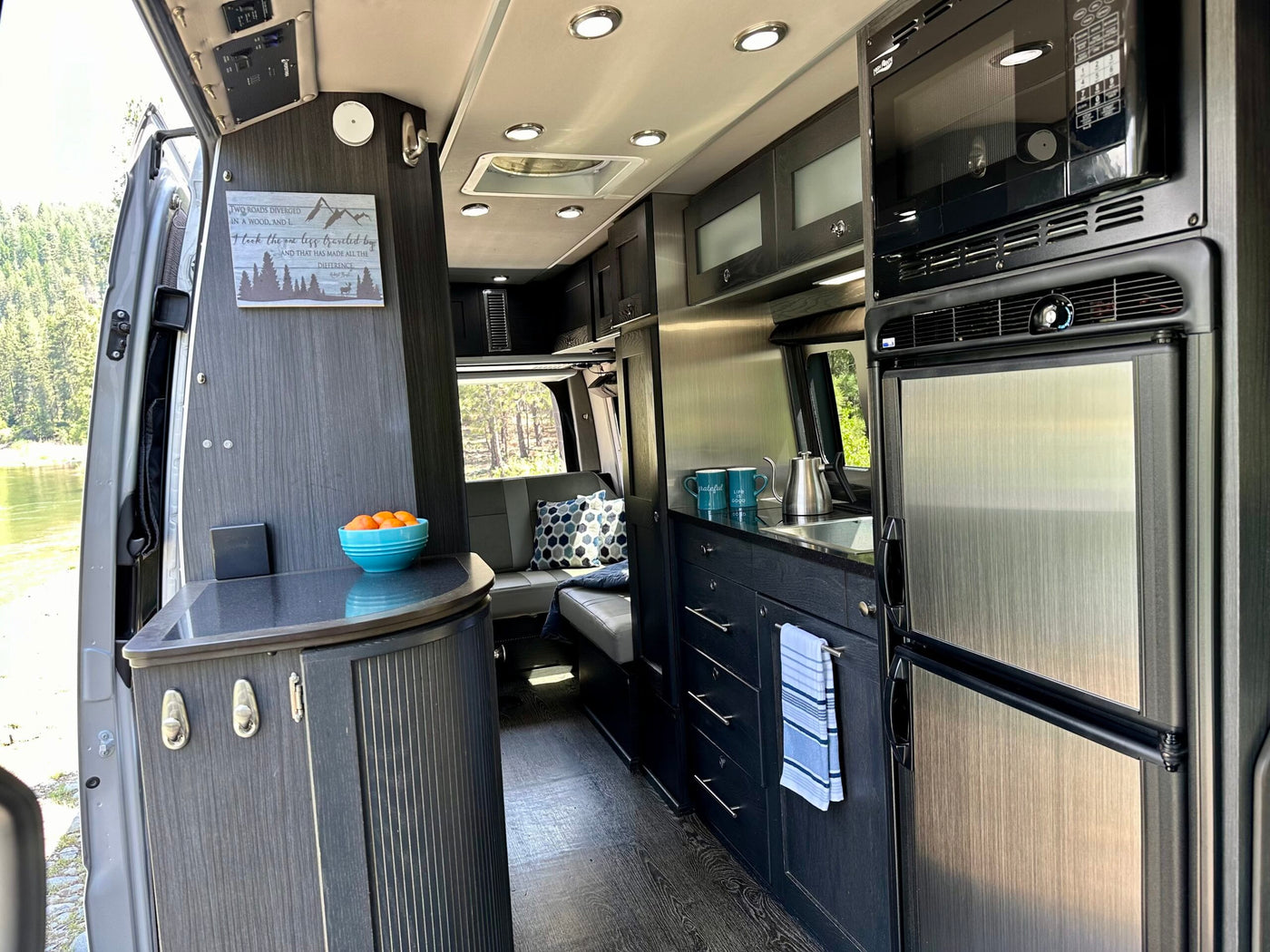  near a river & forest.|Spacious rv rental interior with a modern kitchen — photo 6