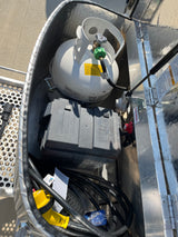 RV rental utility compartment: propane tank, battery, and electrical power cords for your trip.