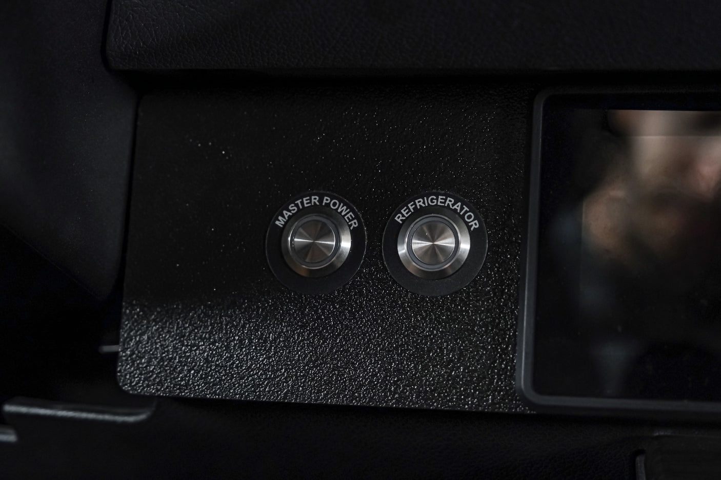 RV rental control panel featuring "Master Power" and "Refrigerator" push-buttons for essential vehicle systems management.