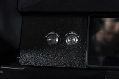 RV rental control panel featuring "Master Power" and "Refrigerator" push-buttons for essential vehicle systems management.