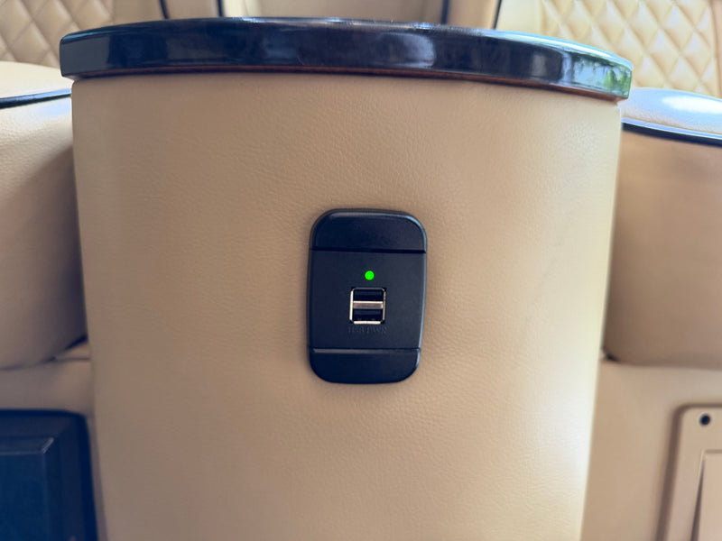 Stay charged on your rv rental adventure! Dual USB power port with an active green indicator light, integrated into cream upholstered seating. — photo 19