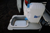 RV rental perk: Translucent water container filling a portable collapsible sink. Perfect for camp kitchens.