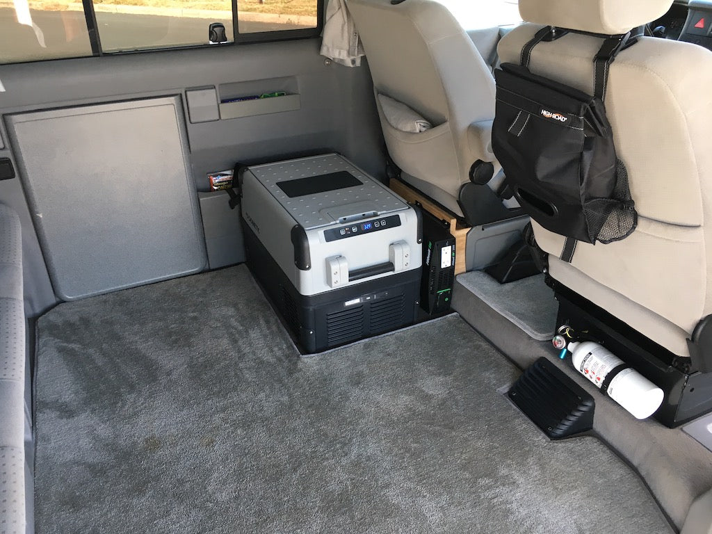 RV rental interior: A portable fridge, power inverter, and fire extinguisher offer amenities for comfortable camper van travel. — photo 6