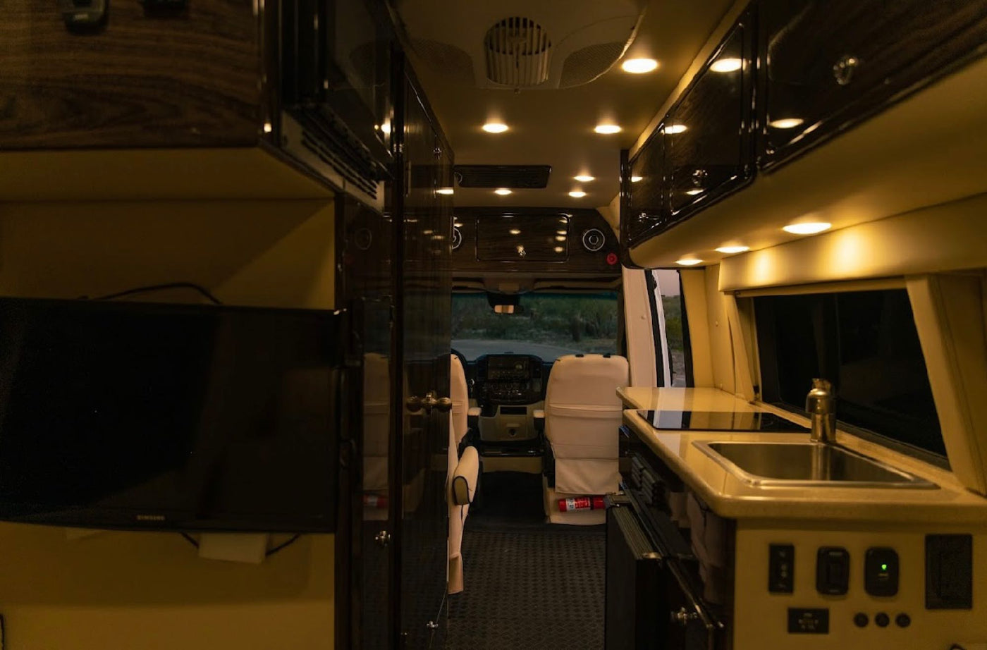  parked on a desert road at sunset.|High-quality audio setup in an RV rental: a JL Audio speaker and Beats by Dre logo on wood paneling — photo 10
