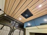Inside a modern **rv rental**: wood plank ceiling, Dometic AC/fan, recessed lighting, and stylish blue cabinets.