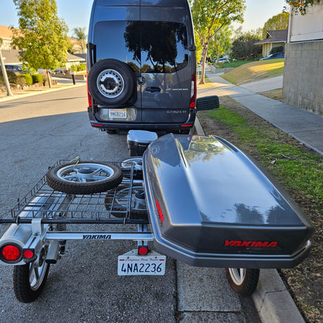 Dark grey RV van with Yakima trailer & cargo box, ready for adventure. Perfect for an rv rental.