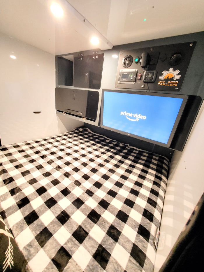  and organized utensils provide a complete camping setup.|This RV rental features a well-equipped outdoor camp kitchen. Visible are a stove