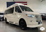 Custom white Mercedes-Benz Sprinter van with off-road tires, ideal for your next RV rental adventure.