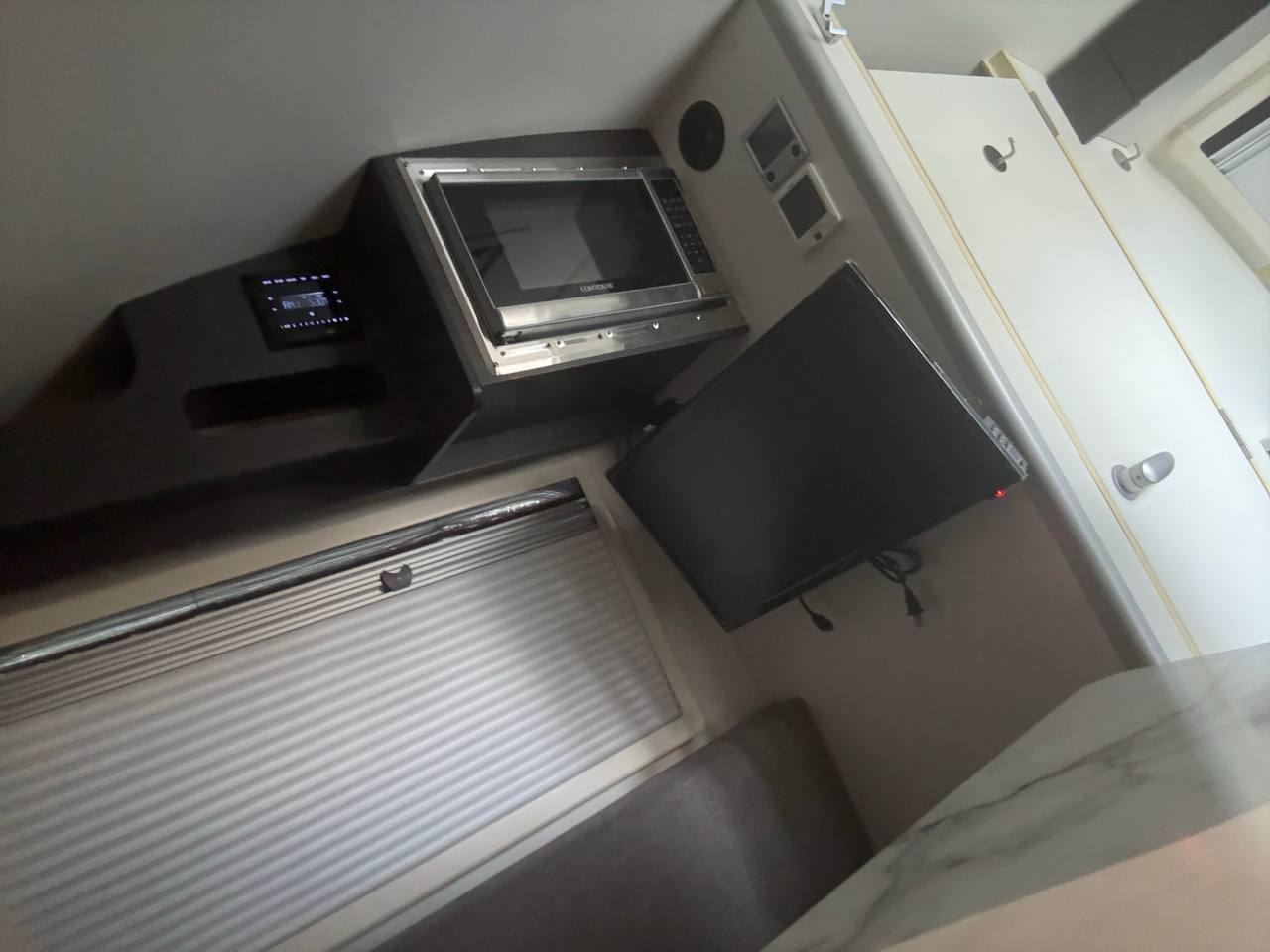  next to a Dometic cooler and seating.|RV rental kitchenette featuring a sleek countertop — photo 17