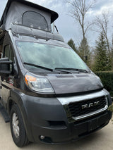Dark grey Ram ProMaster camper van with pop-top roof, ideal for your next RV rental adventure.