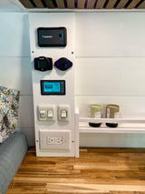 RV rental interior showing Renogy battery monitor, Webasto heater control, USB, outlets, and tea shelf for comfort.