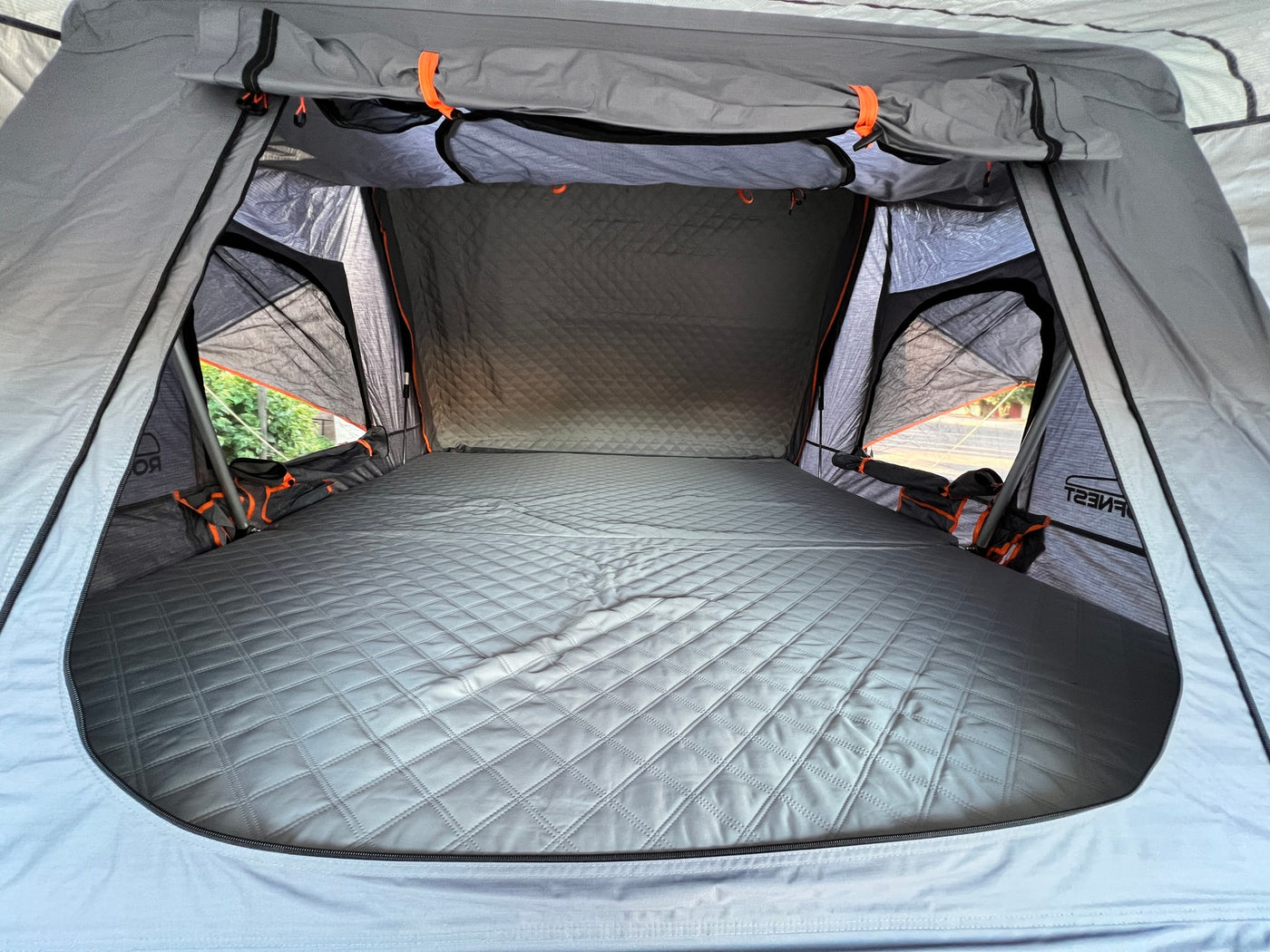 Spacious interior of a rooftop tent with a quilted mattress, ready for comfortable RV rental camping trips. — photo 6