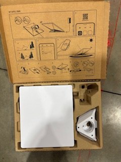 Open Starlink kit showing router, mount & instructions. Essential satellite internet for your RV rental adventures.