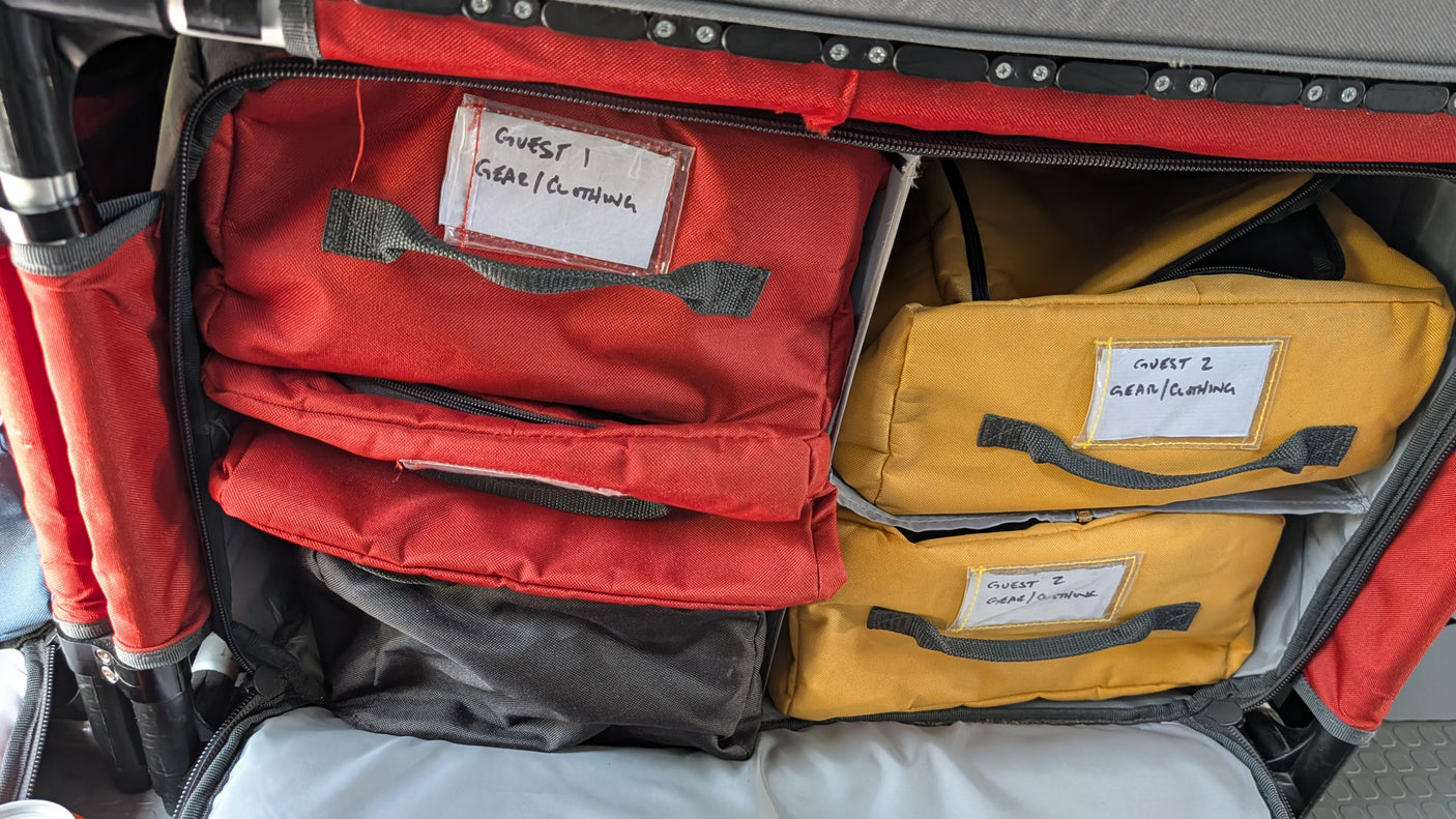 RV rental packing: neatly organized gear/clothing bags for Guests 1 and 2 inside a travel organizer, making travel easy.
