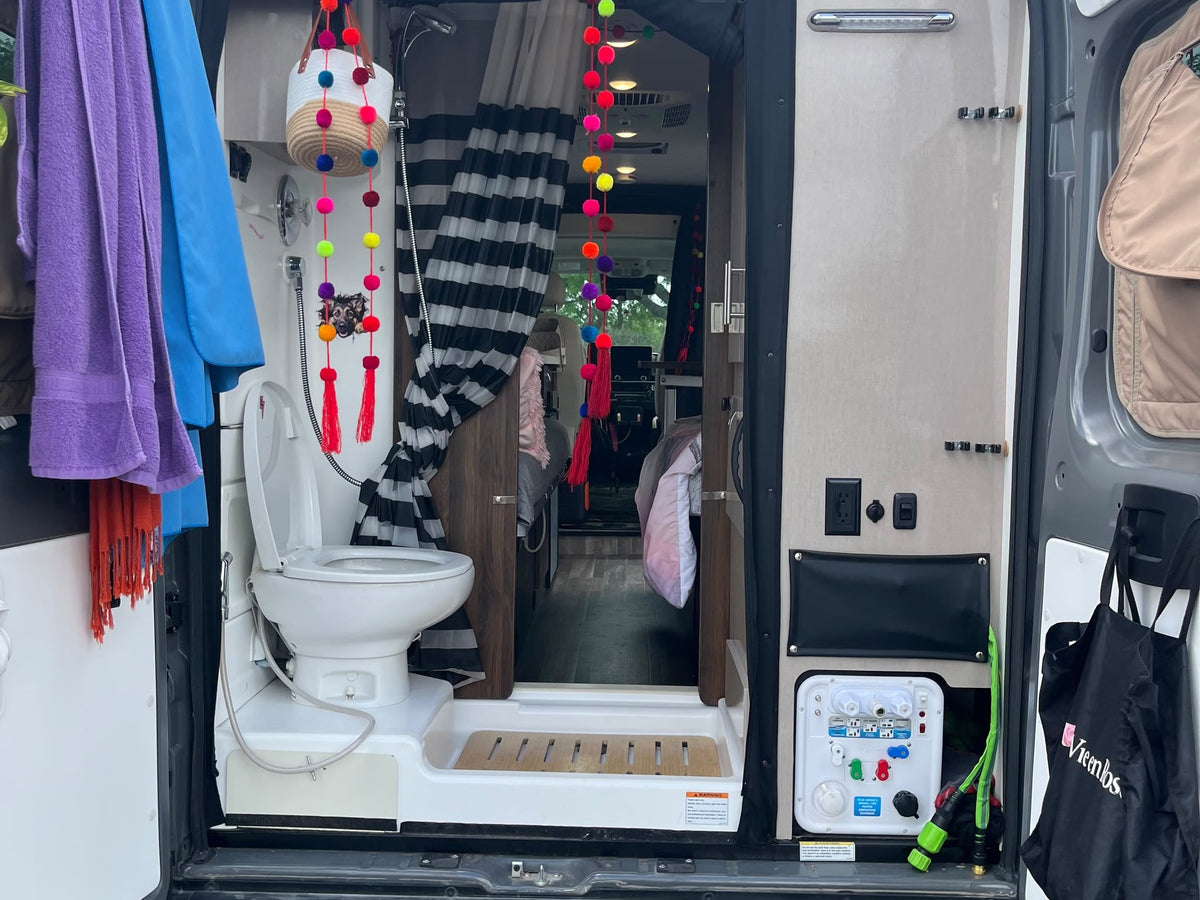  is parked in a lot on a cloudy day.|Inside a cozy RV rental: two beds with stylish bedding — photo 4