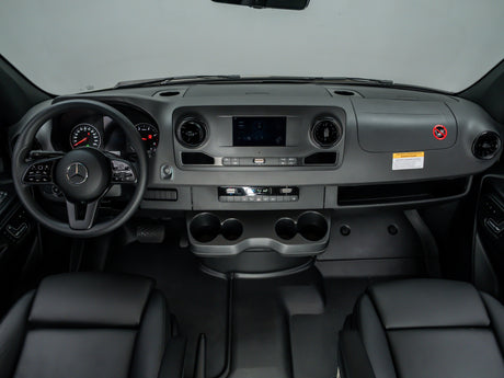 Inside an RV rental: a Mercedes-Benz dashboard with steering wheel, infotainment, and climate controls, ready for adventure.