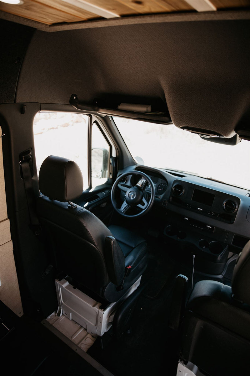  enjoying the desert view at dusk. Perfect for an RV rental trip.|Inside an RV rental camper van: driver's seat — photo 4