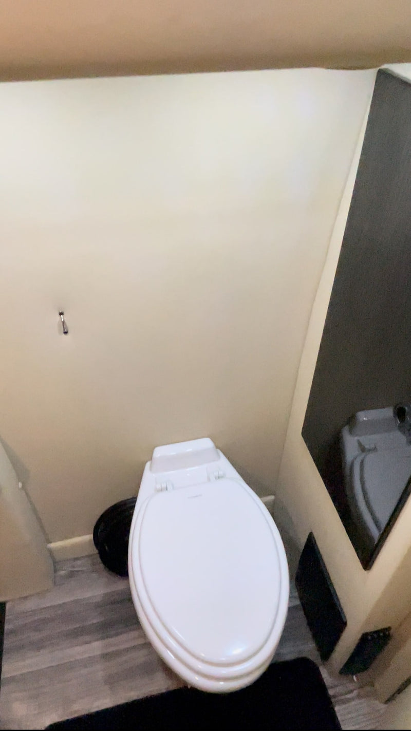  tech-ready travel cabin.|This luxury RV rental features a spacious custom interior with cream captain's chairs — photo 6