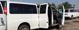 White passenger vans, similar to those for rv rental or large group transport, with doors open.